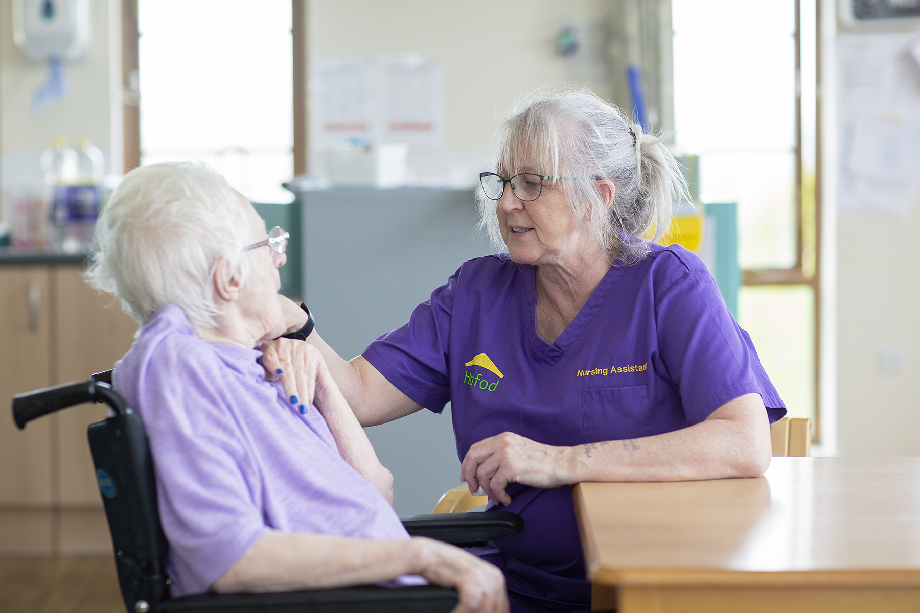 Carer speaking with resident at Brocastle Manor Care Home