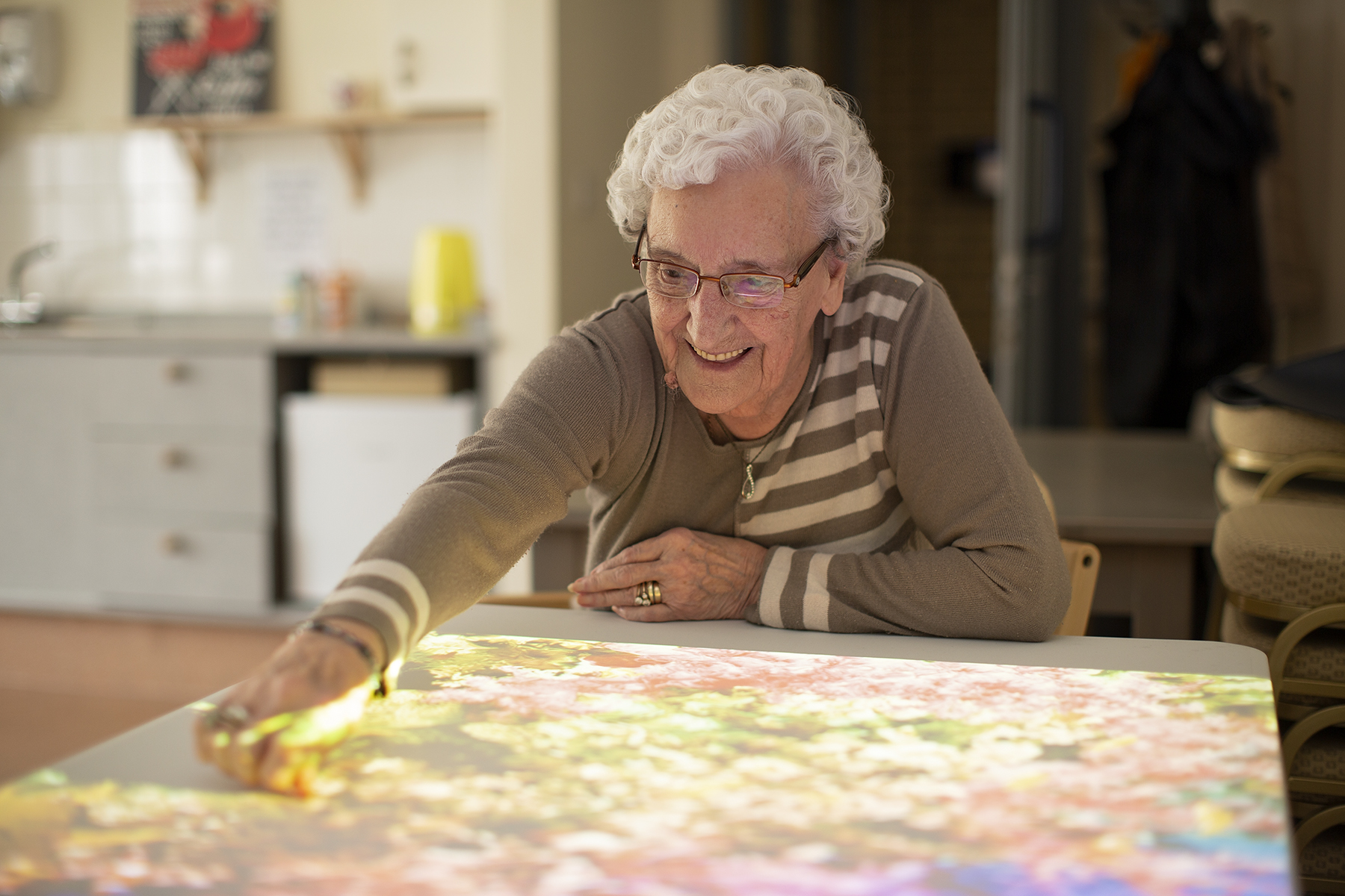 Resident using touch screen game at Cwmbran House Care Home