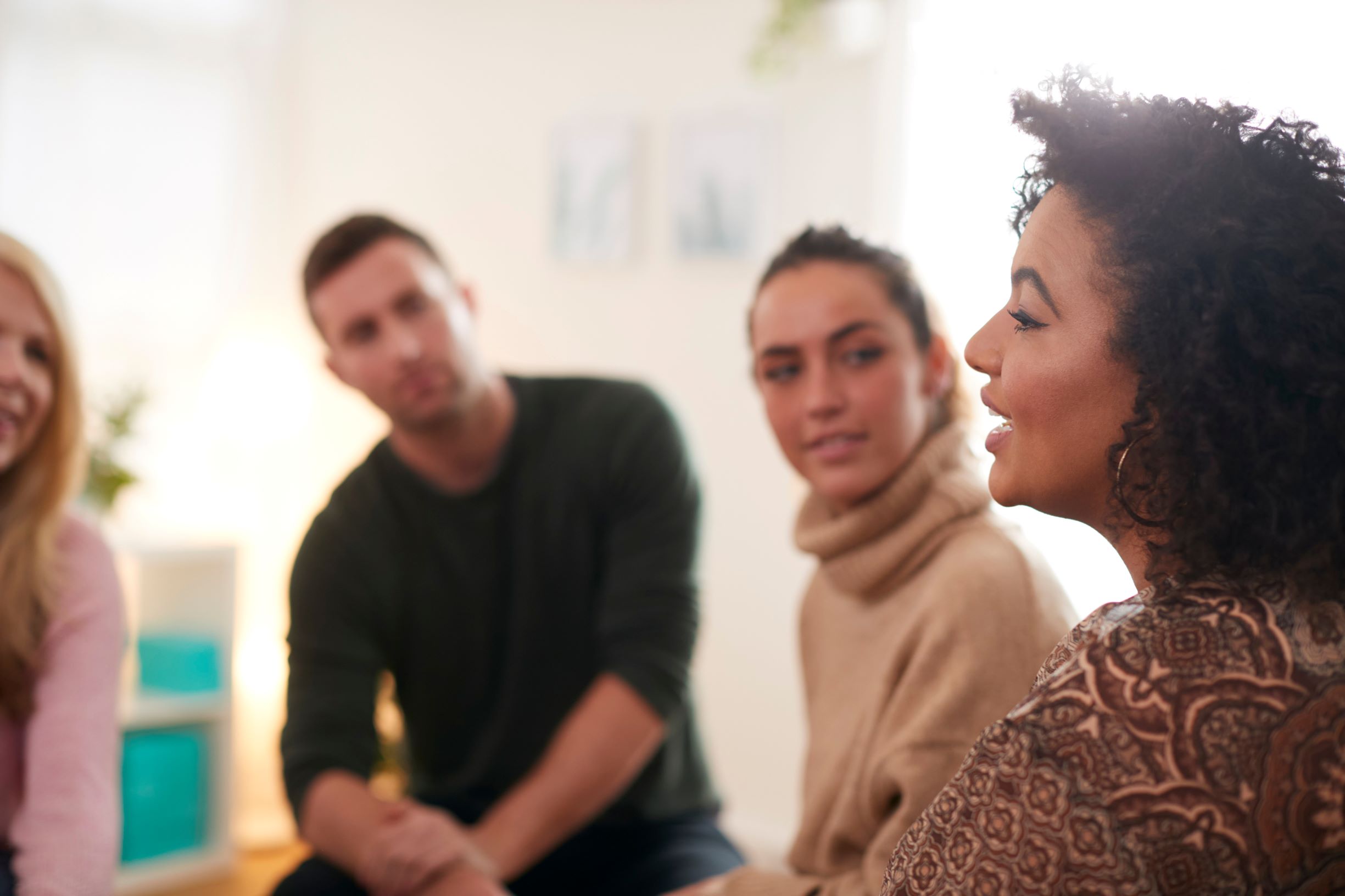 Group of people listening to a lady speak