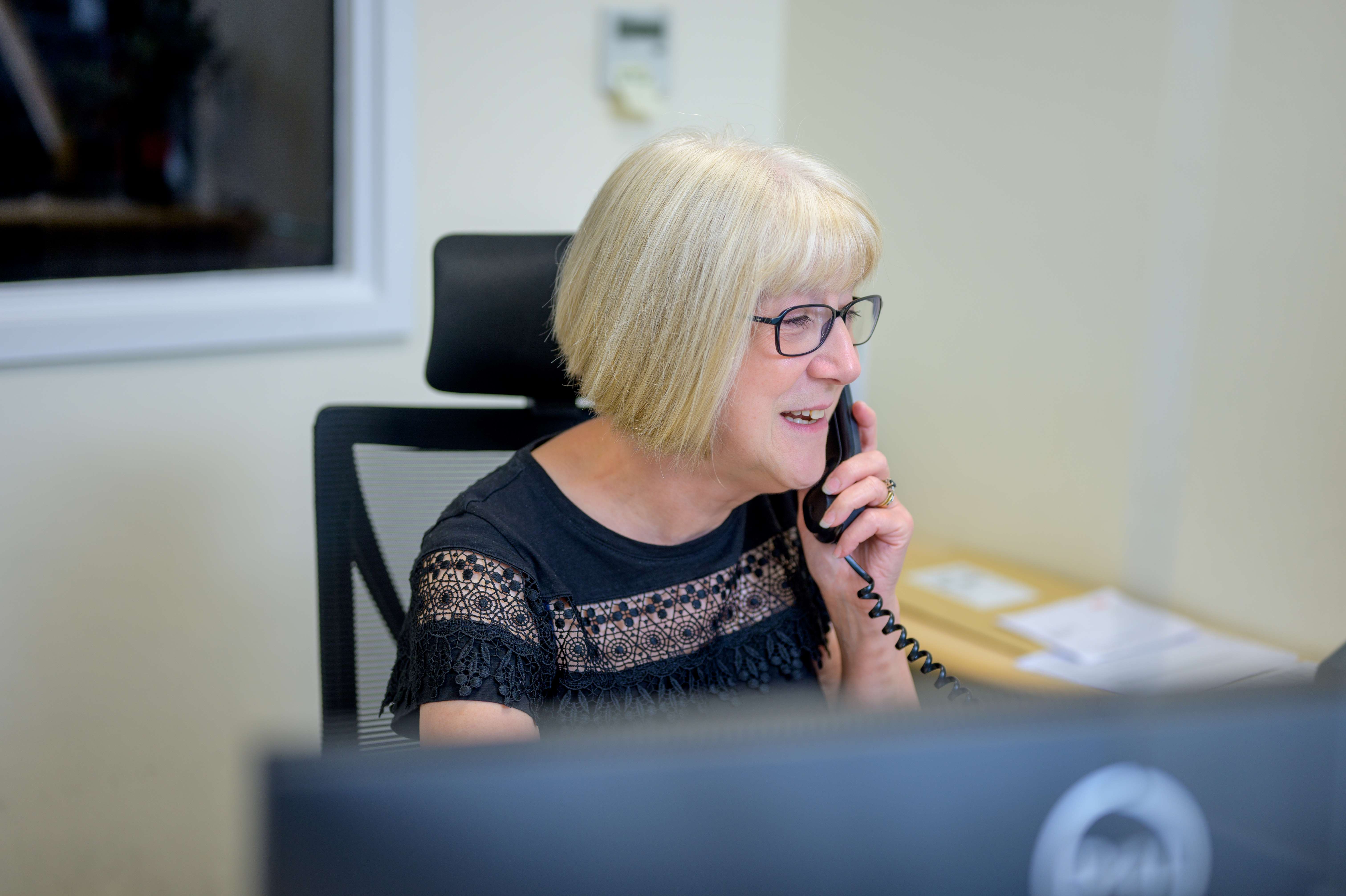 Lady on the phone at her desk