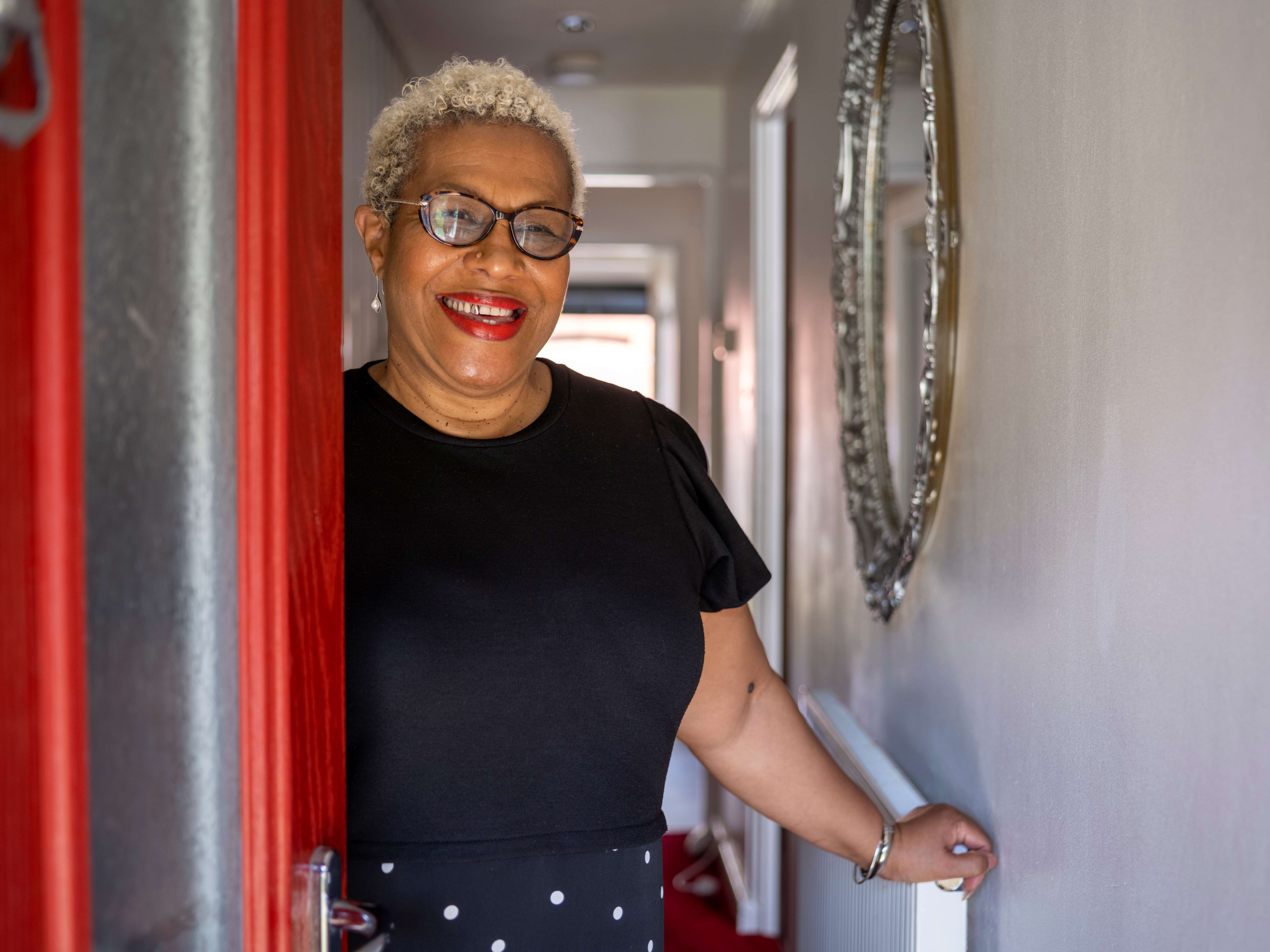 Lady opening her front door with a smile