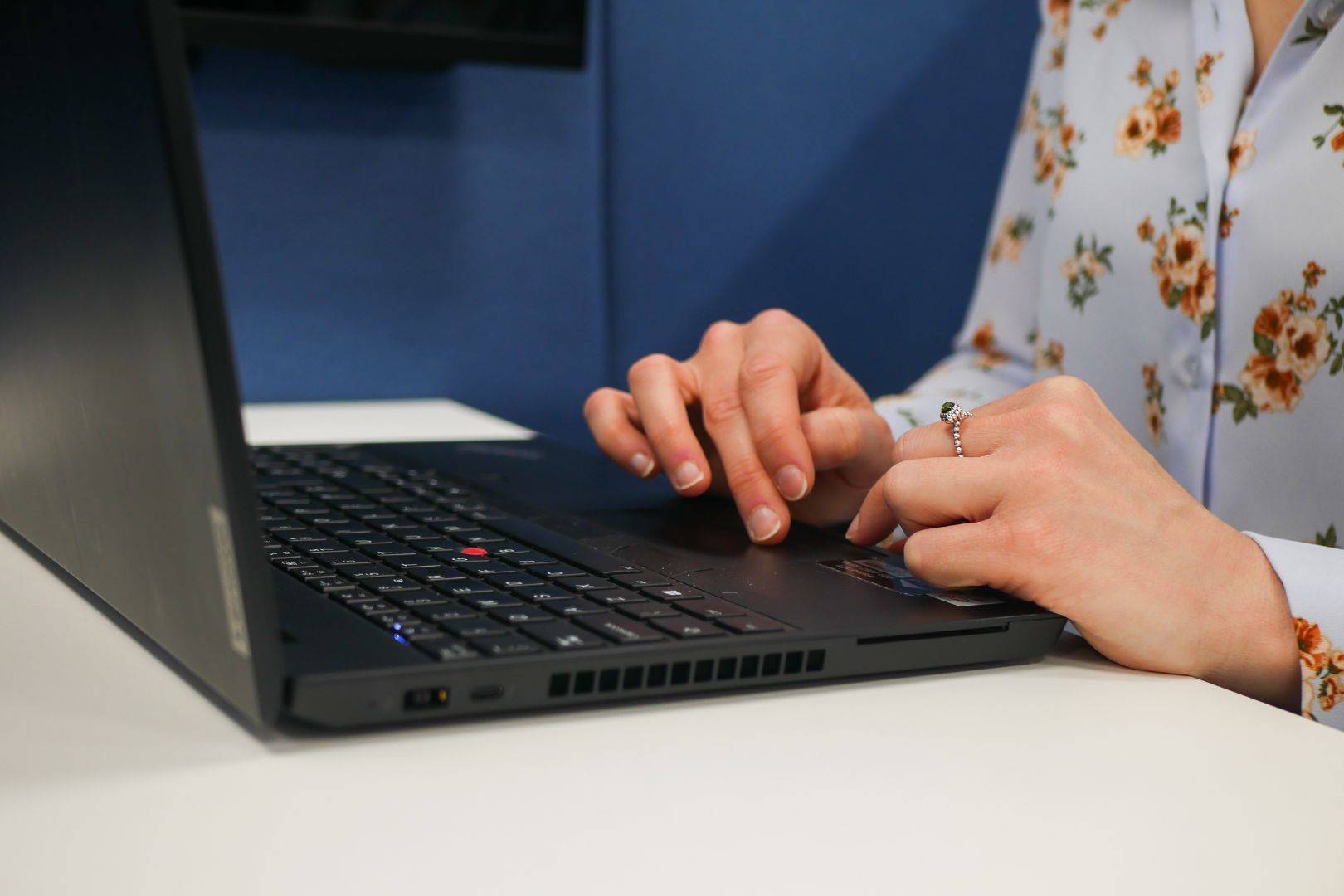 Close up of a colleague working on their laptop at head office