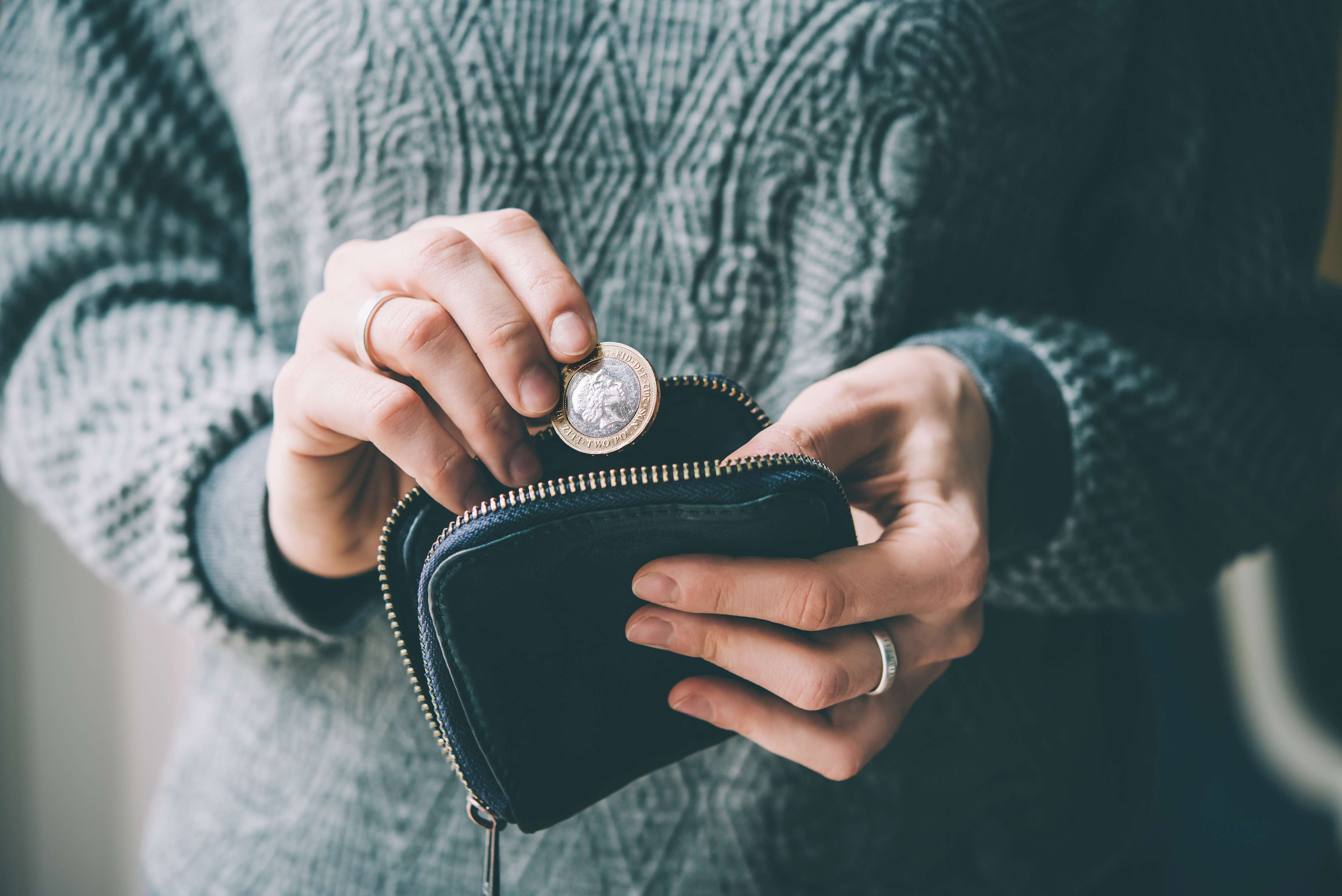 Woman putting money in her purse