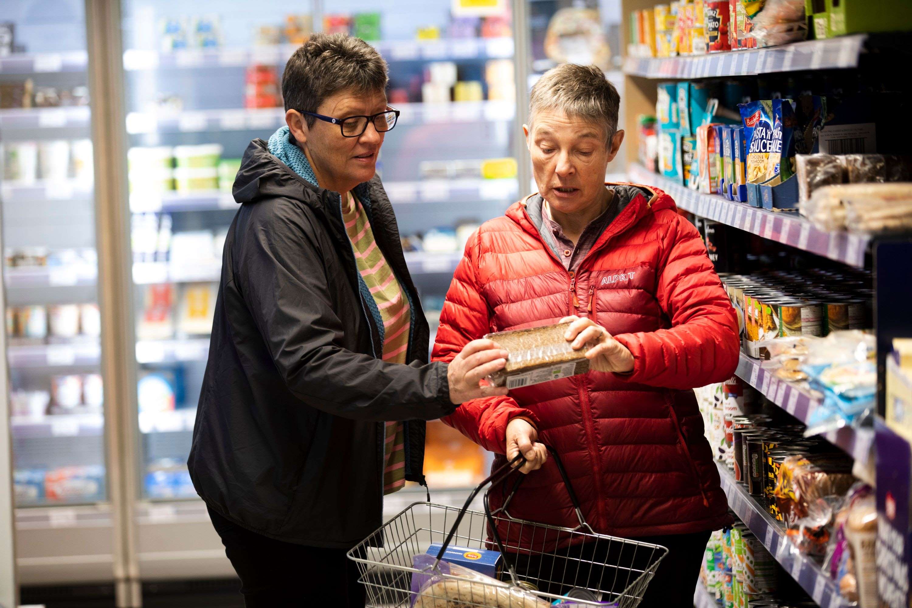 Two ladies shopping in the bread aisle